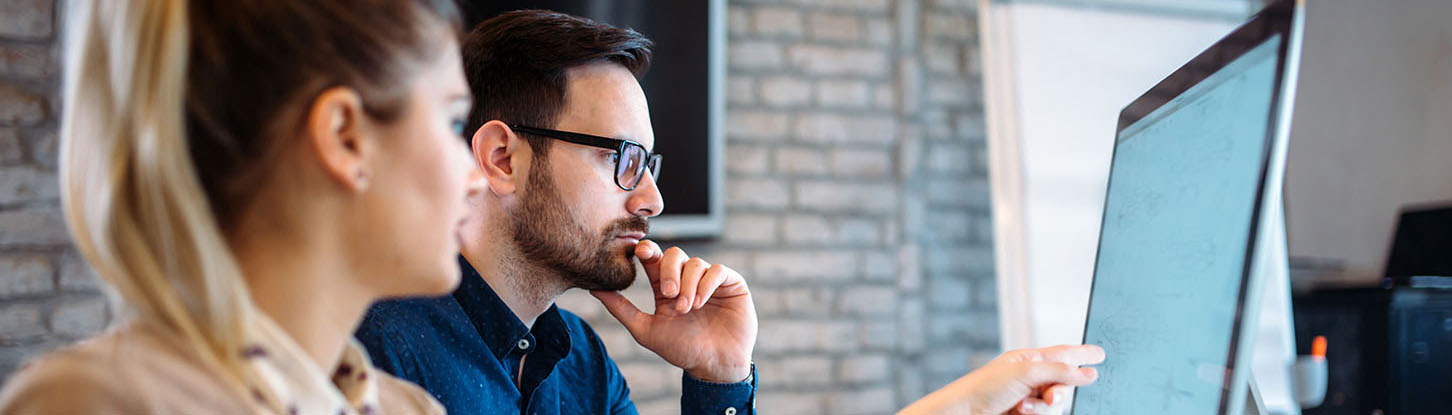 Woman and man looking at computer
