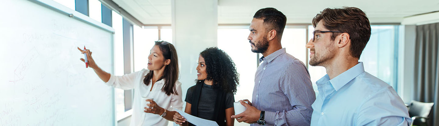 Four people in whiteboard session